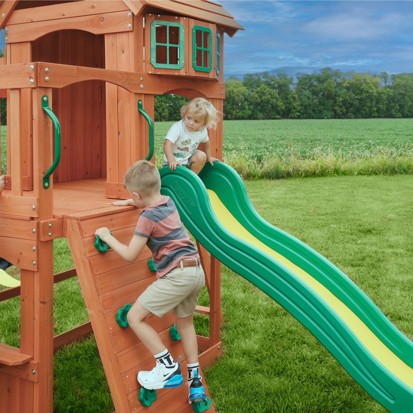 Backyard Discovery Atlantis Cedar Wood Swing Set with Wave Slide, Raised Clubhouse, Rock Wall, Belt Swings, Trapeze, Balcony, Lower Play Space, Snack Bar, Sandbox Area, Step Ladder, Outdoor Playset